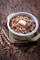 Barley porridge with butter in green pot 