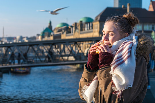 Woman eating traditional north german food fish snack