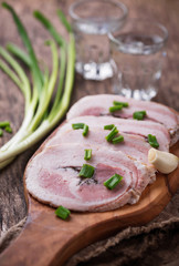 Slices of bacon with green onion and garlic 
