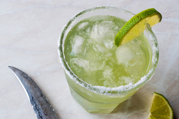 Classic Margarita Cocktail in Salted Glass with Lime and Crushed ice.