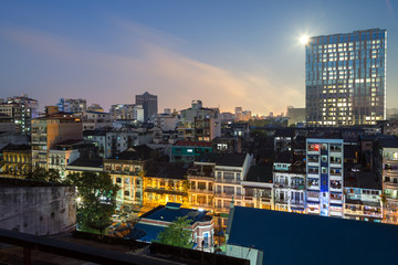 Old and new lit buildings at the downtown in Yangon (Rangoon), Myanmar (Burma), in the evening.