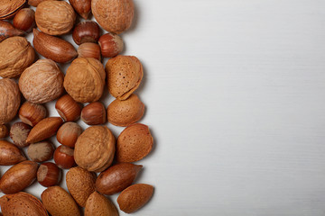 Nuts on white wood background 