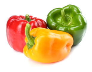 three green, red, yellow sweet bell peppers isolated on white background