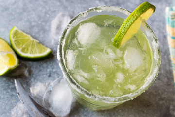 Classic Margarita Cocktail in Salted Glass with Lime and Crushed ice.