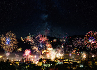 rockets firework at new years day in front of snowy mountains