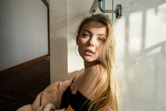 Bewitching blonde woman looks seductively at the camera