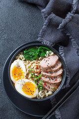 Japanese ramen soup with duck breast, egg, chives and spinach