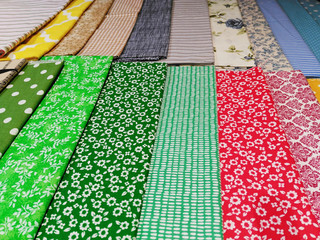 Colorful woven cotton fabric samples, multicolored textile texture background.