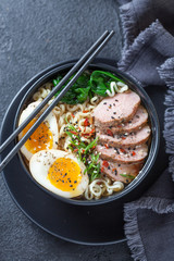 Japanese ramen soup with duck breast, egg, chives and spinach