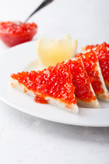 Red salmon caviar served on toast