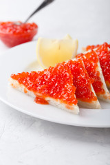 Red salmon caviar served on toast