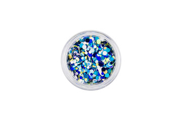 Confetti for manicure. Round beautiful sequins for nail design in manicure and pedicure. Decorative particles. Fish scales for decoration. Blue, white, azure, marine in a small glass jar.