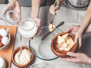 Mothers and children's hands cook dough for home-made cookies. We cook in kitchen together with children. Happy family