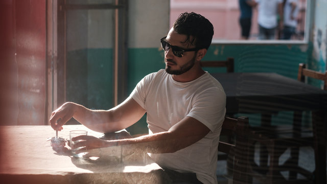 Man Smoking Cigarette At The Bar