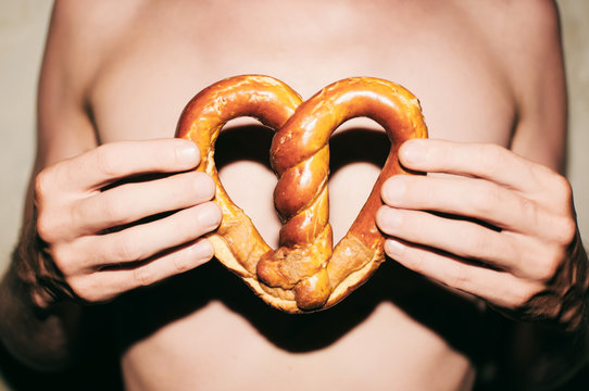 Man holding heart-shaped pretzel