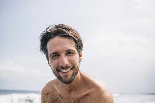 Portrait of happy man on beach