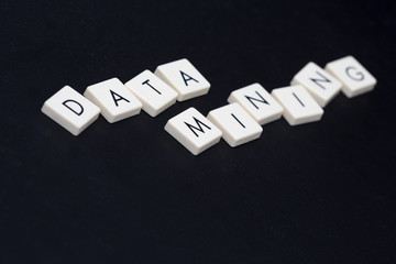 Data mining text on a black leather surface. Data mining is usually referred to bitcoin virtual currency.