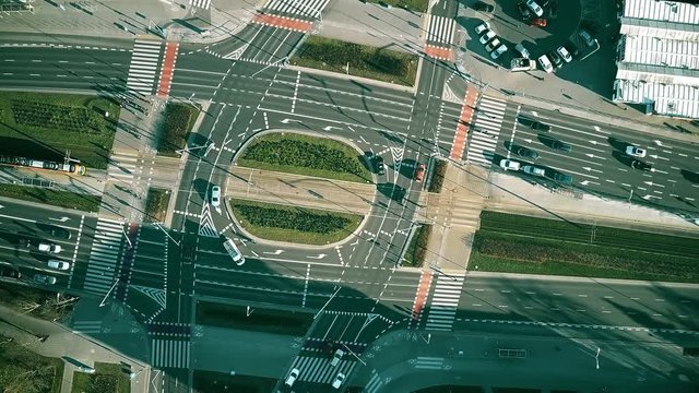 Aerial top down view time lapse of road traffic on big intersection