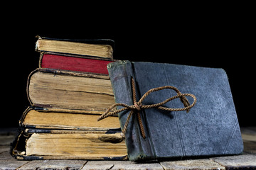 Old destroyed books on a wooden table. Reading room library with very old books on a wooden table.