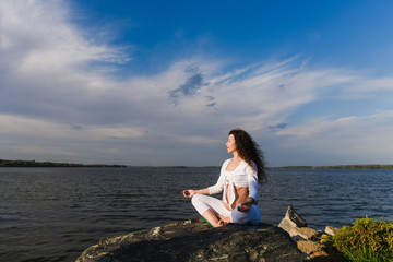 Meditating pregnant woman in lotus position.
