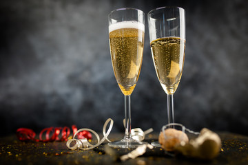 Two champagne glasses in golden glitter