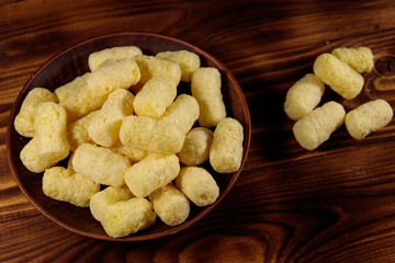 Sweet corn sticks on a plate on wooden table