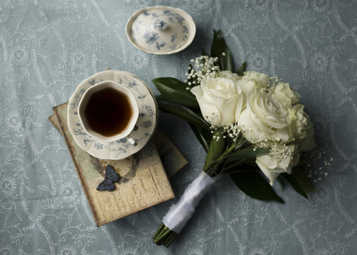 Coffee cup and flowers on table