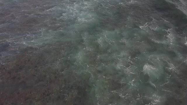 Top view on ocean with reef. Big waves. Surf spot. Drone fly over water. Blue water. Wild ocean.