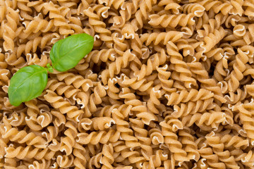 Uncooked wholemeal pasta isolated white background.