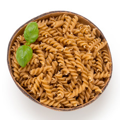 Uncooked wholemeal pasta isolated white background.