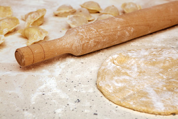 rolling pin and dough on table