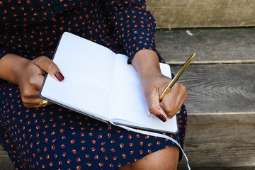 Woman writing in notebook