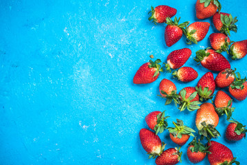 Market fresh ripe strawberries on blue vibrant background