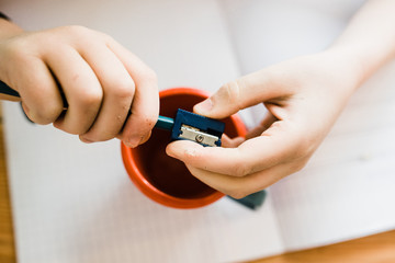 child writing in notebook