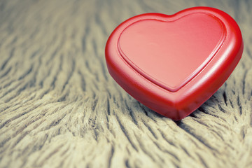 Red heart on wooden board to romantic and sweet day for Valentines Day.