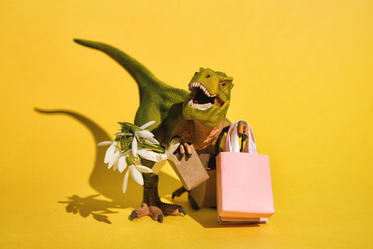 Funny small T-Rex with bags and flowers