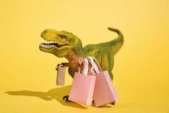 Toy T-Rex with shopping bags