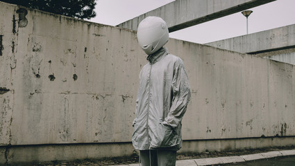Abstract scene with person with white helmet/mask and silver jacket