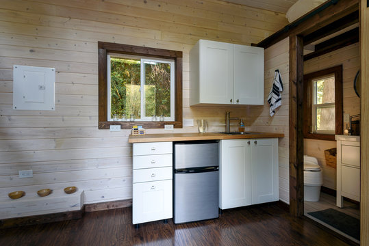 Interior design of a kitchen in a tiny rustic log cabin.