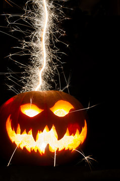 Sparkler Trail Leading Into A Halloween Pumpkin