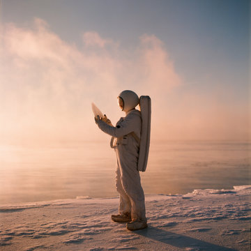 Astronaut standing among ice