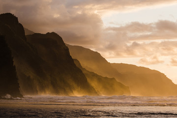 crashing waves and cliffs at sunset in Hawaii