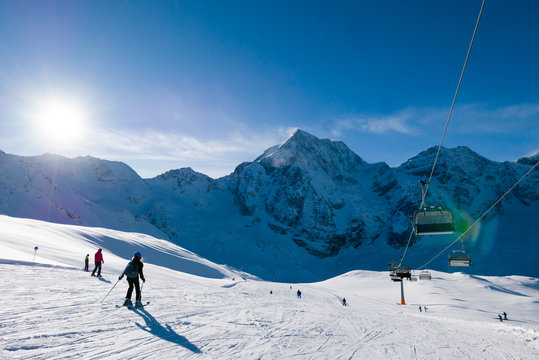 Ski holiday, sunny day in popular Alpine ski resort, Solda (Sulden), South Tyrol, Italy