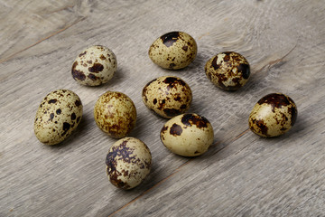 Quail eggs on a wooden background