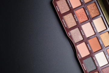 Set of flat top view of eye shadow shades of chocolate on black background, Cosmetics concept, Makeup concept, Copy space image for your text, Flat lay.