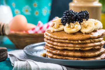 Close up of pancakes with fresh blackberries,banana and walnut