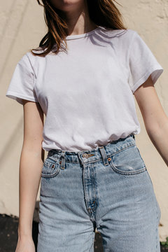 close up of a woman's torso in tshirt and jeans
