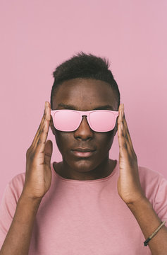 Portrait of young man with pink eyeglasses and t shirt