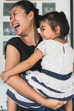 Asian woman holding kid