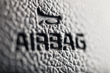 close up of symbol of airbag on steering wheel